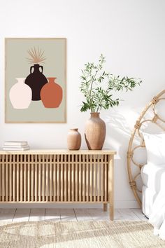 a bedroom with a bed, plant and poster on the wall next to a wooden dresser