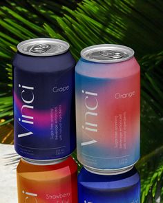 three cans of orange, grape and strawberry soda sitting next to each other on a table