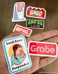 several stickers on the palm of a person's hand that is holding them