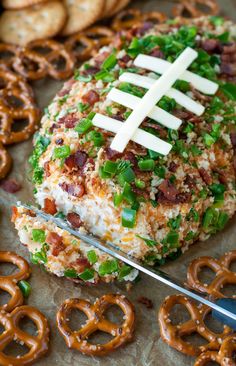 a football shaped appetizer with pretzels on the side