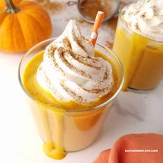 two glasses filled with pumpkin spice and whipped cream