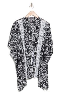 Love to layer this lightweight ruana that is covered in a mixed print and trimmed with crochet lace. 28" length (size O/S) Open front Short sleeves 100% rayon Hand wash, dry flat Imported Black Bohemian Printed Cover-up, Bohemian Spring Kimono With Lace Trim, Open Front Lace Trim Cover-up For Festivals, Festival Lace Kimono With Lace Trim, Bohemian Beach Kimono With Lace Trim, Bohemian Lace Kimono With Lace Trim, Bohemian Kimono With Lace Trim For Vacation, Beach Bohemian Kimono With Lace Trim, Prom Shopping