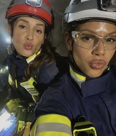 two women in firefighter gear posing for a photo