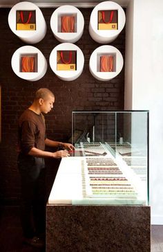 a man standing in front of a display case