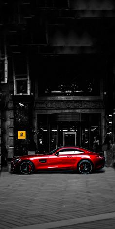 a red car parked in front of a building