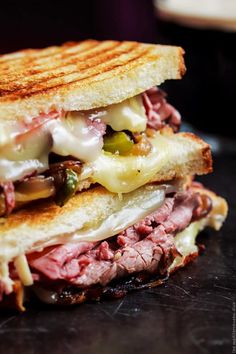 a grilled sandwich with meat, cheese and vegetables