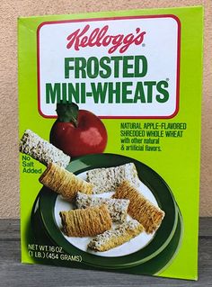 a box of frozen food sitting on top of a wooden table next to an apple