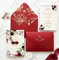 red and gold wedding stationery with floral envelopes