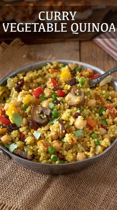 a bowl filled with rice and vegetables on top of a table