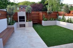 an outdoor garden with artificial grass and plants