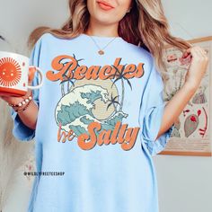 Our beaches be salty vacation shirt makes the perfect addition to your spring break or summer vacation! This shirt is super cute and soft. It is made of 100% high quality comfort colors® tee making it perfect for the warmer temps. You will love it! Please be sure to check sizing and measurements in the photos section. ALSO if you would like an oversized tshirt dress look then please order at least 2 sizes up from your normal size. If you have any questions please feel free to reach out and I wil Trendy Relaxed Fit Camp Shirt For The Beach, Casual Beach Camp Shirt With Letter Print, Casual Letter Print Camp Shirt For Vacation, Casual Camp Shirt With Letter Print For Vacation, Beachy Relaxed Fit Shirt For Vacation, Relaxed Fit Summer Shirt For Beach Party, Beachy Relaxed Fit Shirt For Spring, Beachy Cotton Shirt With Relaxed Fit, Casual Cotton Shirt For Beach Party