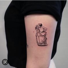 a woman's arm with a small tattoo of a man sitting on a chair