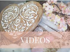 two heart shaped wooden boxes sitting on top of a lace covered table