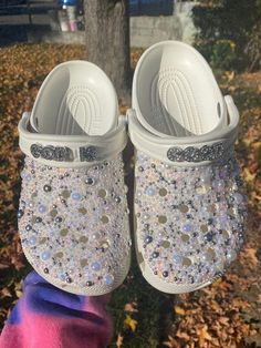 These crocs that I made are not only extremely comfortable and extremely fashionable all at the same time. They are custom made differently for each and every person so they're one of a kind. Each pair is fully customizable with different colors,charms, and but not limited to names and/or phrases. Junk Crocs, Wedding Crocs, Croc Ideas, Taylor Swift Shoes, Crocs With Charms, Bling Crocs, Cross Shoes, Bedazzled Shoes, Curvy Casual Outfits