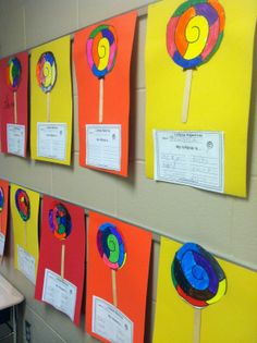 several colorful lollipops are hanging on the wall next to each other in a classroom