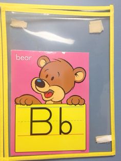 a bear on a yellow sign with the letter b in it