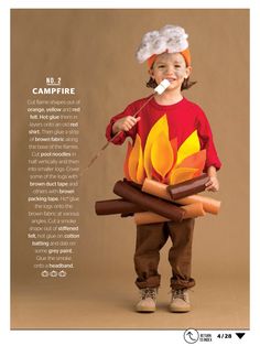 a little boy dressed up like a campfire with marshmallows on it