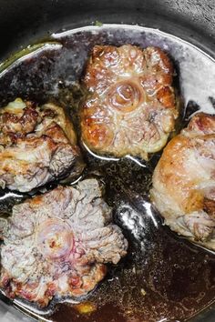 some meat is cooking in a pan on the stove