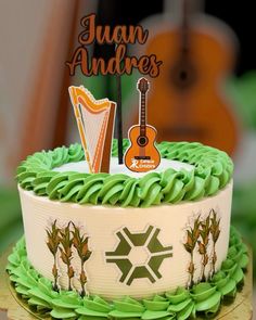 a cake with green icing and a guitar on top that says juan andrewss