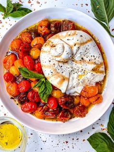 a white bowl filled with lots of different types of food on top of a table