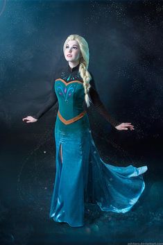 a woman dressed as frozen queen standing in the water