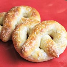 two soft pretzels on a red plate