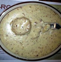 a bowl filled with soup sitting on top of a table next to a paper napkin