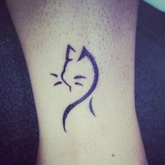 a small cat tattoo on the ankle