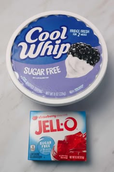 a bowl of jello next to a card on a counter top with the word cool whip written in it