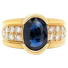 a blue sapphire and diamond ring set in yellow gold