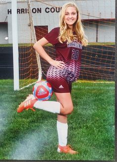 a female soccer player is posing for a photo