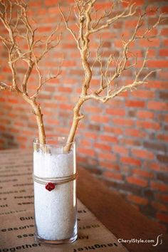 a small vase with some branches in it