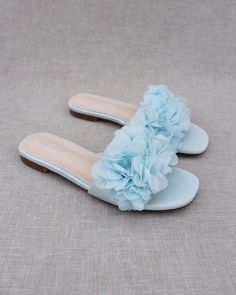 "Classic slide flat sandals for casual and dressy look with added chiffon flowers all over. Simple and easy wear for brides, bridesmaids and/ or wedding parties. DETAILS: COLORS AVAILABLE: Ivory, Light Blue, White, Pink, and Champagne UPPER: Synthetic upper and lining MATERIALS: Mandmade outsole STYLE NAME: EVELYN Not sure of which size to purchase? Shoes measurements are as follow: (Please note measurements taken the length of inside of shoe from toe to heel) Size 5.5 - 9.25\" Size 6 - 9.40\" S Cheap Blue Sandals For Outdoor Activities, Cheap Light Blue Sandals For Vacation, Cheap Blue Non-slip Sandals, Cheap Blue Summer Slides, Cheap Casual Light Blue Sandals, Cheap Blue Slip-on Sandals, Blue Bridal Shoes Sandals, Cheap Blue Sandals For Beach Season, Affordable Blue Beach Slides