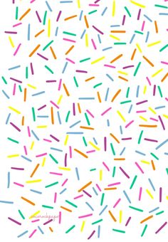 colorful sprinkles on a white background are featured in this image, and the colors appear to be multicolored