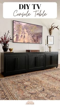 a tv console table in front of a painting on the wall with text overlay that reads diy tv console table