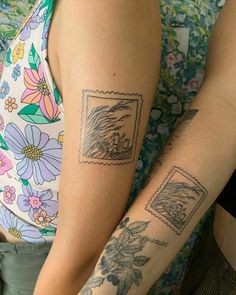 two people with tattoos on their arms and one has a stamp on it's arm