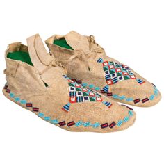 Arapaho beaded men’s moccasins of brain tanned deer skin with parfleche soles. Trunk piece, unused condition. Great display piece. Period: First quarter of the 20th century Origin: Arapaho Size: 10" x 4" W x 3" H Family Owned & Operated Cisco’s Gallery deals in the rare, exceptional, and one-of-a-kind pieces that define the history of America and the Old West. Our pieces range from American Indian to Cowboy Western and include original items of everyday life, commerce, art, and warfare that tame Native American Moccasins, Handmade Moccasins, Indian Beadwork, Indian Arts, Beaded Moccasins, Plains Indians, Native American Beadwork, Bubble Art, American Indian Art