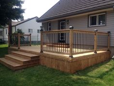 a wooden deck in front of a house