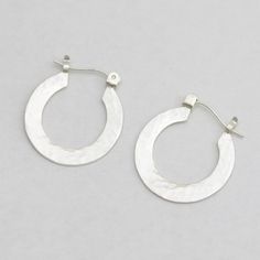 These handcrafted sterling silver hoop earrings are a must have! Feel like a diva every time you put them on! These are crafted by hand using sterling silver sheet that is cut into a "rim", then an opening is made for the earlobe. The rim is polished and pieces of hoop findings are soldered to the top. The fine silver is raised to the surface to remove firescale and to help prevent tarnishing. Then the earrings are brought to a shiny, glossy finish. One side is given a hammered texture, the othe Adjustable Classic Hoop Earrings In Sterling Silver, Nickel Free Sterling Silver Open Circle Jewelry, Nickel-free Sterling Silver Open Circle Jewelry, Sterling Silver Earrings With Silver Clasp, Adjustable Classic Sterling Silver Hoop Earrings, Classic Adjustable Sterling Silver Hoop Earrings, Silver Hypoallergenic Open Circle Jewelry, White Gold Huggie Earrings With Sterling Silver, Nickel-free Sterling Silver Hoop Earrings For Everyday