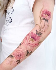 a woman's arm with pink flowers on it