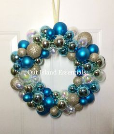 a blue and silver christmas ornament hanging on a door