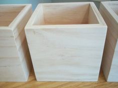 three wooden boxes sitting on top of a table