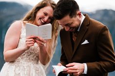 a man and woman are reading a book together