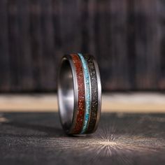 a wedding band with two different colored stones inlayed to the inside of it