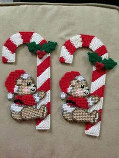 two christmas decorations made to look like the numbers 10 and 11 with a teddy bear holding a candy cane