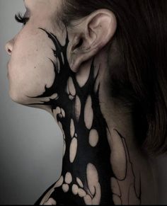 a woman with black and white tattoos on her neck