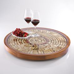 two glasses of wine are sitting on a cork coaster