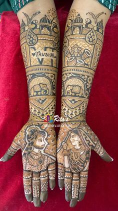 the hands and feet of a woman with henna tattoos on their arms, both covered in intricate designs