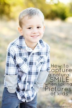 a little boy smiling for the camera with his hands in his pockets and wearing a plaid shirt