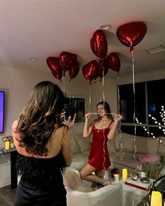 two women in a living room with balloons